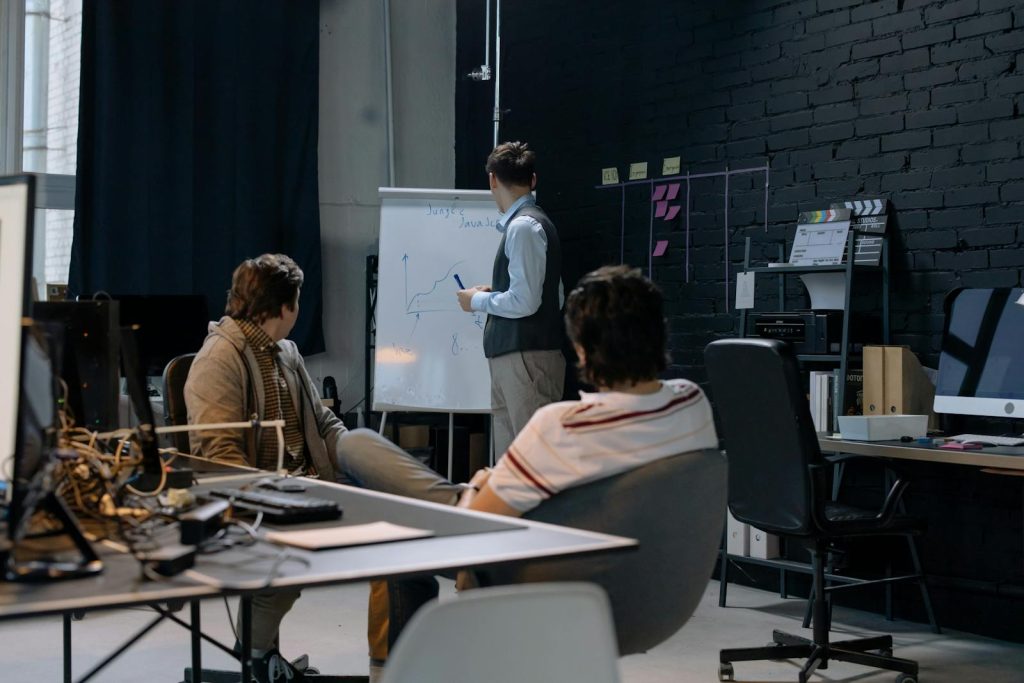 Business meeting with a presentation on growth charts in a contemporary office setting.